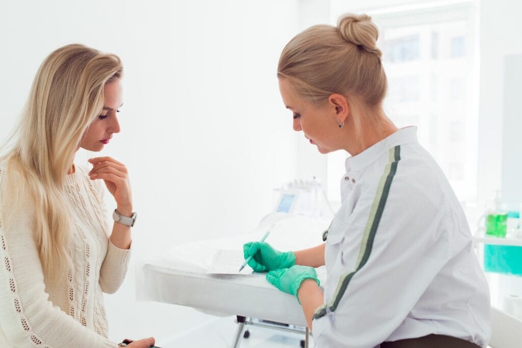 A qualified injector consulting with a patient about Botox and filler treatments, emphasizing the importance of clear communication and personalized care during the consultation process.